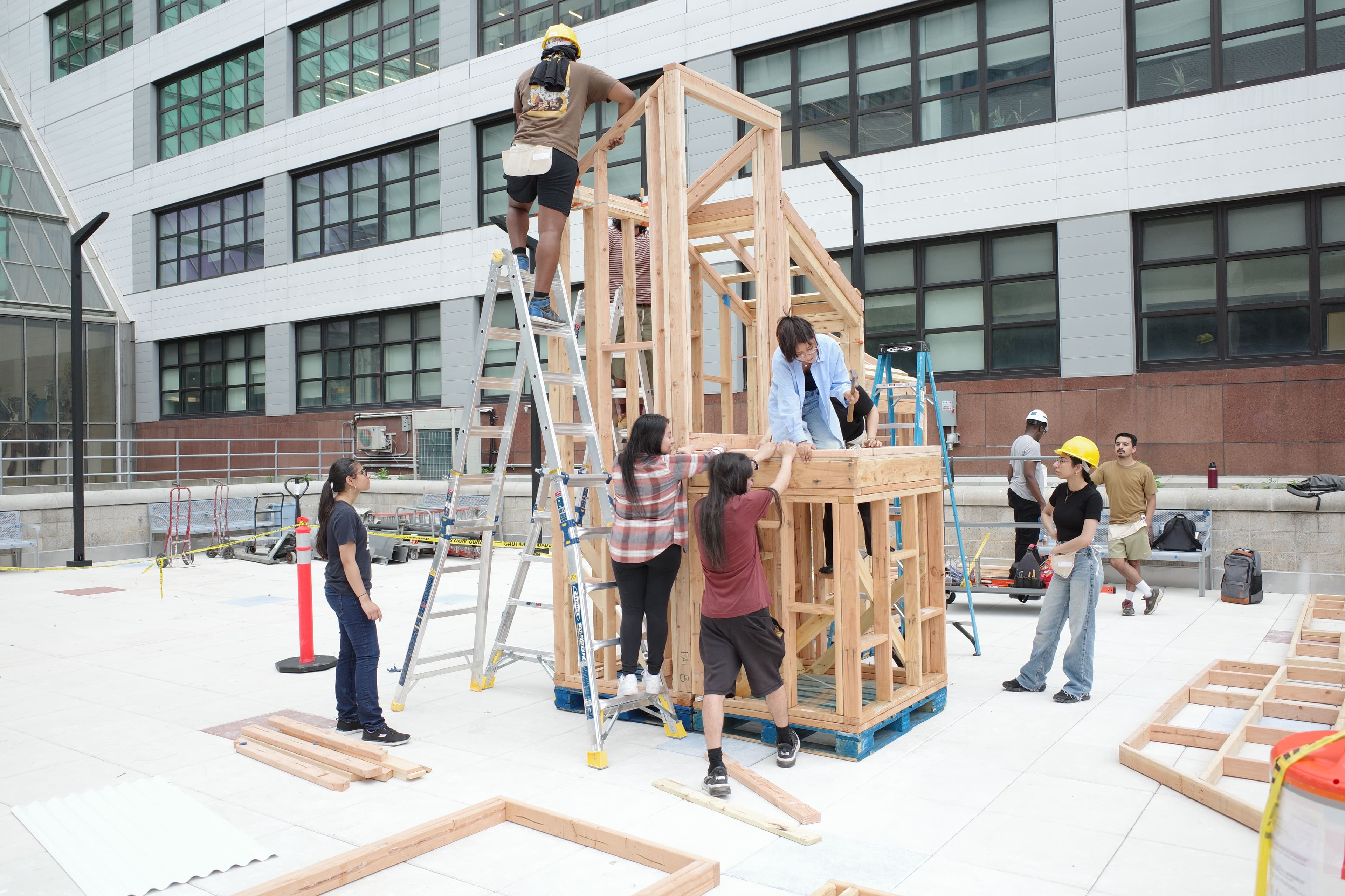 students constructing wood frame installation